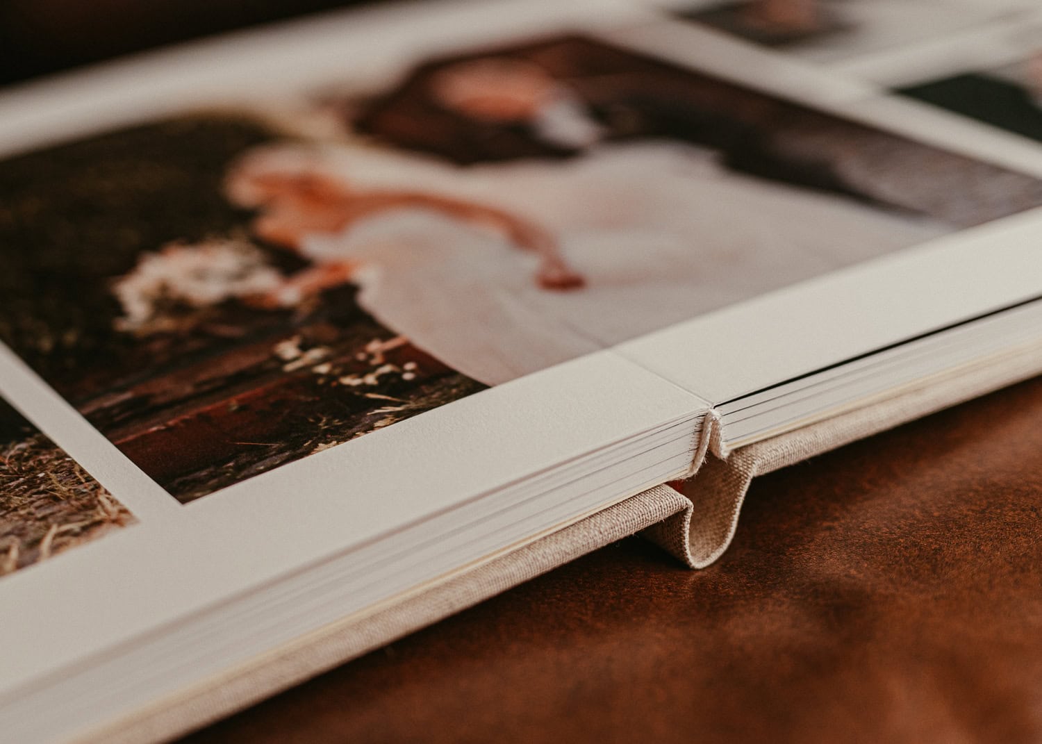 Nahaufnahme eines offenen Hochzeitsalbums mit Fotos des Brautpaares.